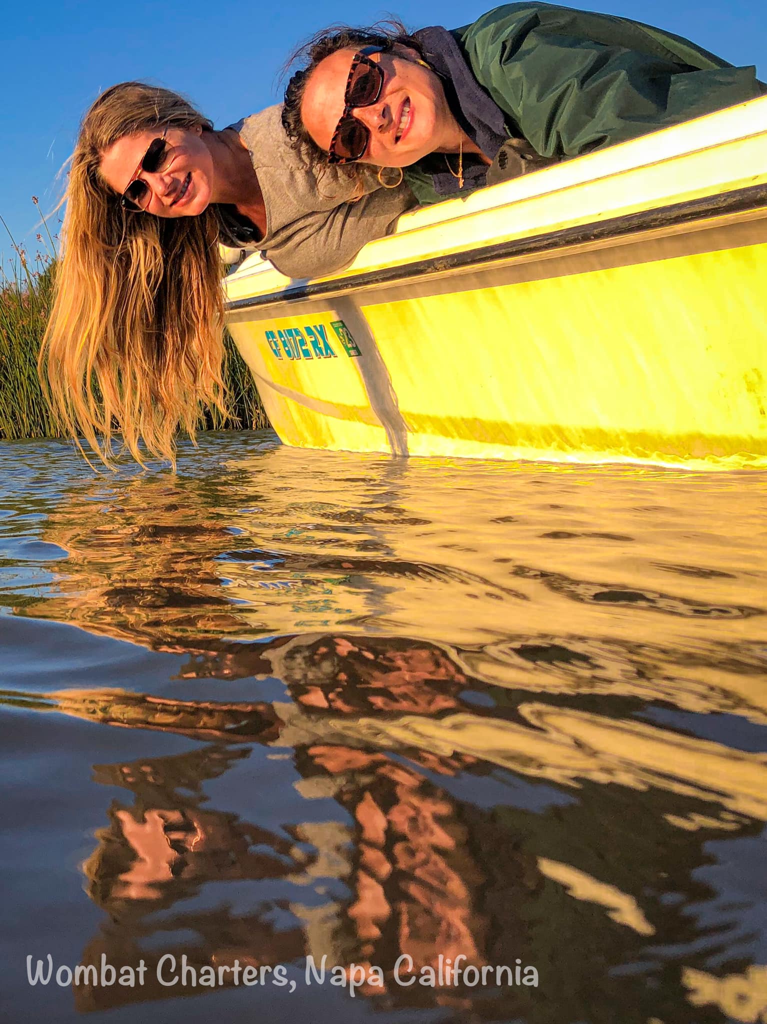 Friends relaxing on a Napa River boat cruise at sunset.